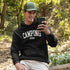 Introducing the ultimate must-have for every outdoor enthusiast who secretly wishes they could bring a slice of home comfort to the wilderness: the "Camping Mode" Hoodie.